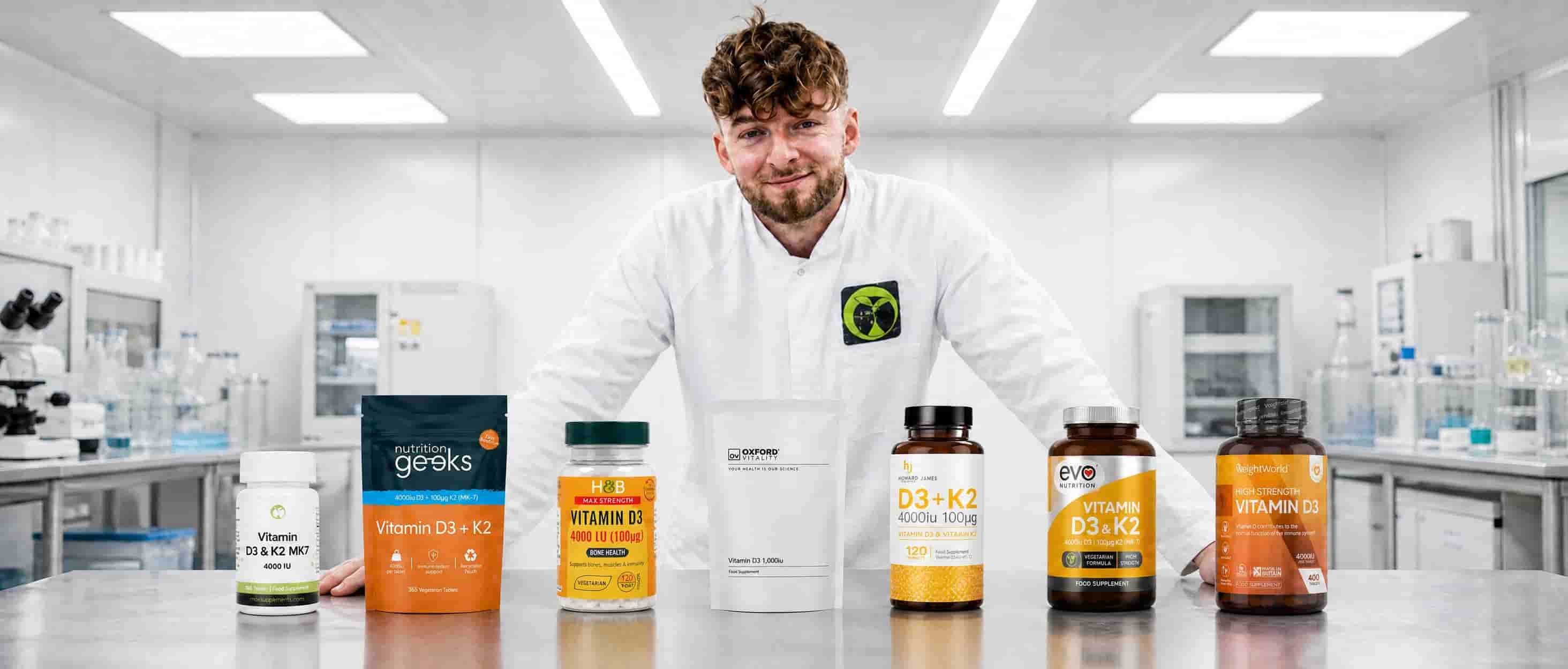Logan in the lab behind seven vitamin D3 supplements bought at retail